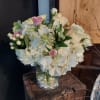 White and pink bouquet in a clear glass vase
