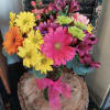 Colorful mixed bouquet in a glass vase with a pink ribbon