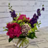 Pink and purple mixed bouquet in a clear glass vase