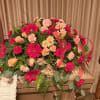 Large casket spray with pink and peach flowers