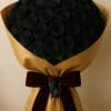 Bouquet of black roses wrapped in gold paper with a burgundy ribbon