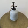 Metal watering can with black spout and twine tag