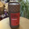 Cylindrical tin of cinnamon cocoa mix on a table
