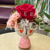 Pink and red floral arrangement in a painted ceramic vase