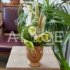 A 3" ceramic pot with embossed and painted features holds a tiny