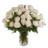 Tall arrangement of white roses in a clear glass cylinder vase