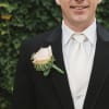 Man in a suit wearing a pale rose boutonniere