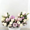 Pastel roses and cosmos arranged in a white bowl vase