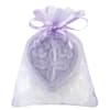 Lavender organza gift bag with a heart-shaped decorative piece and white crystals inside.