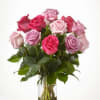 Bouquet of pink and lavender roses in a clear glass vase