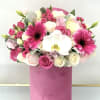 Pink and white bouquet with roses, gerbera daisies, and an orchid in a pink box
