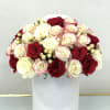 Bouquet of red and white roses in a white hat box