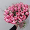 Bouquet of pink tulips with small white filler flowers