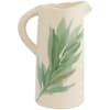 Cream ceramic pitcher with a green leaf design