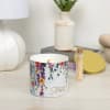 Floral-scented candle in a white jar with 