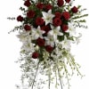 Standing floral spray with red roses and white lilies on a metal easel