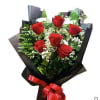 Bouquet of red roses with white filler flowers wrapped in black paper