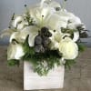 White calla lilies and roses arranged in a white wooden box
