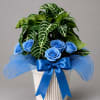Vivid blue roses take center stage in this blue-and-green gift arrangement, making
