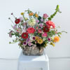 A vibrant, garden-inspired mix of seasonal blooms, Easter Morning Glow is a