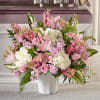 Pink and white floral arrangement in a white vase