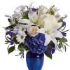 White lilies and daisies with blue hydrangea in a cobalt vase