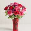 Bouquet of pink and red roses in a red textured vase
