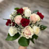 A rounded hand-tied rose arrangement that reads like a classic garden bouquet-red
