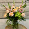 Soft peach roses and pink snapdragons soften into a bright green hydrangea
