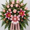 Pink roses, pink lilies, with a pink bow make this spray really