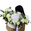 Stylish basket with flowers, in green and fresh shades,   for