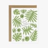Greeting card with green tropical leaves and the words 