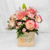Pink and cream floral arrangement in a 