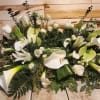 Large white floral arrangement with calla lilies and roses