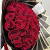 Bouquet of red roses wrapped in black and gold paper