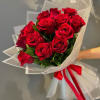 Bouquet of red roses wrapped in white paper with a red ribbon