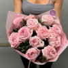 Bouquet of pale pink roses wrapped in pink paper