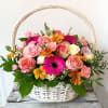 A Wicked-style floral basket featuring a fresh seasonal mix of blooms. Each