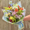 A cheerful garden-style bouquet that brightens any celebration - perfect as a