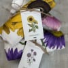 Bold sunflowers and delicate purple asters print across soft kitchen towels to