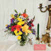 Colorful mixed bouquet in a clear glass vase with lilies and roses