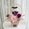 A charming preserved flower arrangement featuring 2 premium deep purple roses and