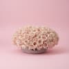 A timeless arrangement of luxurious blush roses artfully designed in a modern