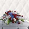 A sloping, red, white and blue casket spray that emanates respect and