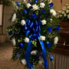 Vivid royal-blue roses paired with crisp white carnations and white spiders with
