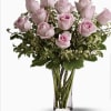 Bouquet of pale pink roses in a clear glass vase