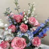 Bouquet of pink roses with blue and white flowers