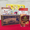 Hawaiian snack gift set with noodle box, cookies, snack bags, and a yellow printed tote.