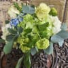 Bouquet of pale green and white flowers with blue accents