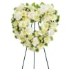 White floral funeral wreath on a standing easel